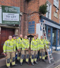 Firemen puttimg up Christmas trees