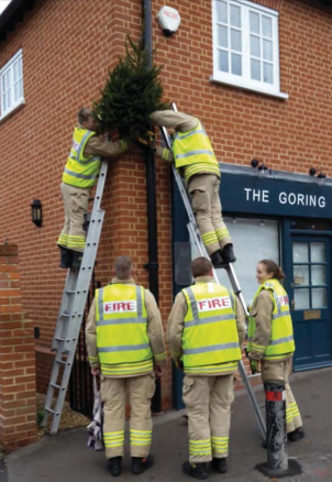 Members of the Goring Fire Service erecting Christmas trees. Photo: Geoff Brown