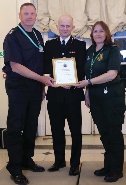 Sean and Sue Absolom receiving their Certificate of Commendation from Chief Fire
Officer, Rob MacDougall (centre) 
Photo: Oxfordshire Fire and Rescue Service